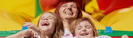 Family laughing on a bounce house